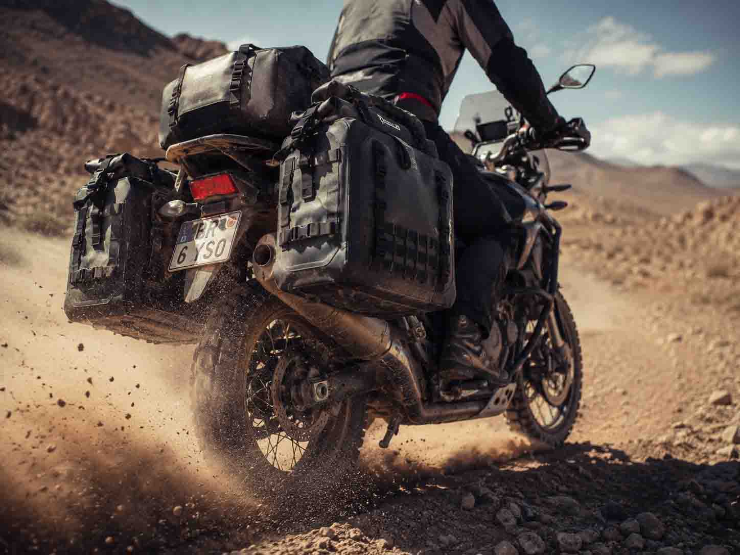 OEM heavy-duty waterproof motorcycle panniers surviving extreme vibration on a desert overlanding adventure. OEM heavy-duty waterproof motorcycle panniers surviving extreme vibration on a desert overlanding adventure.